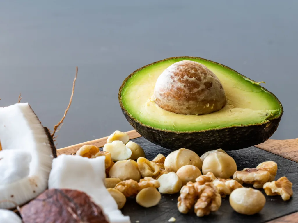Foods with good fats, coconut, avocado and mixed nuts