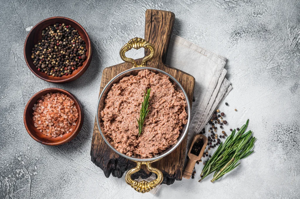 Plant based meat displayed with salt, pepper and herbs